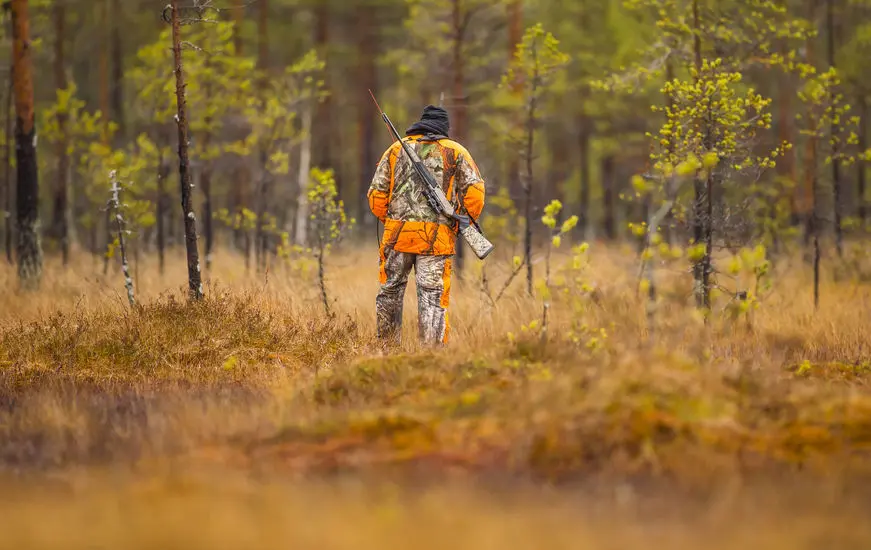 Hunter standing in field